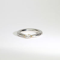 Halo silver ring with a marquise diamond in a 18ct setting by Charmian Ottaway