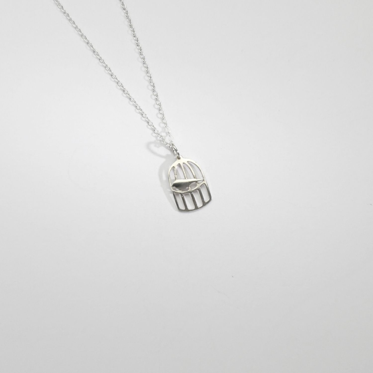 Mini silver birdcage pendant by Kate Wimbush