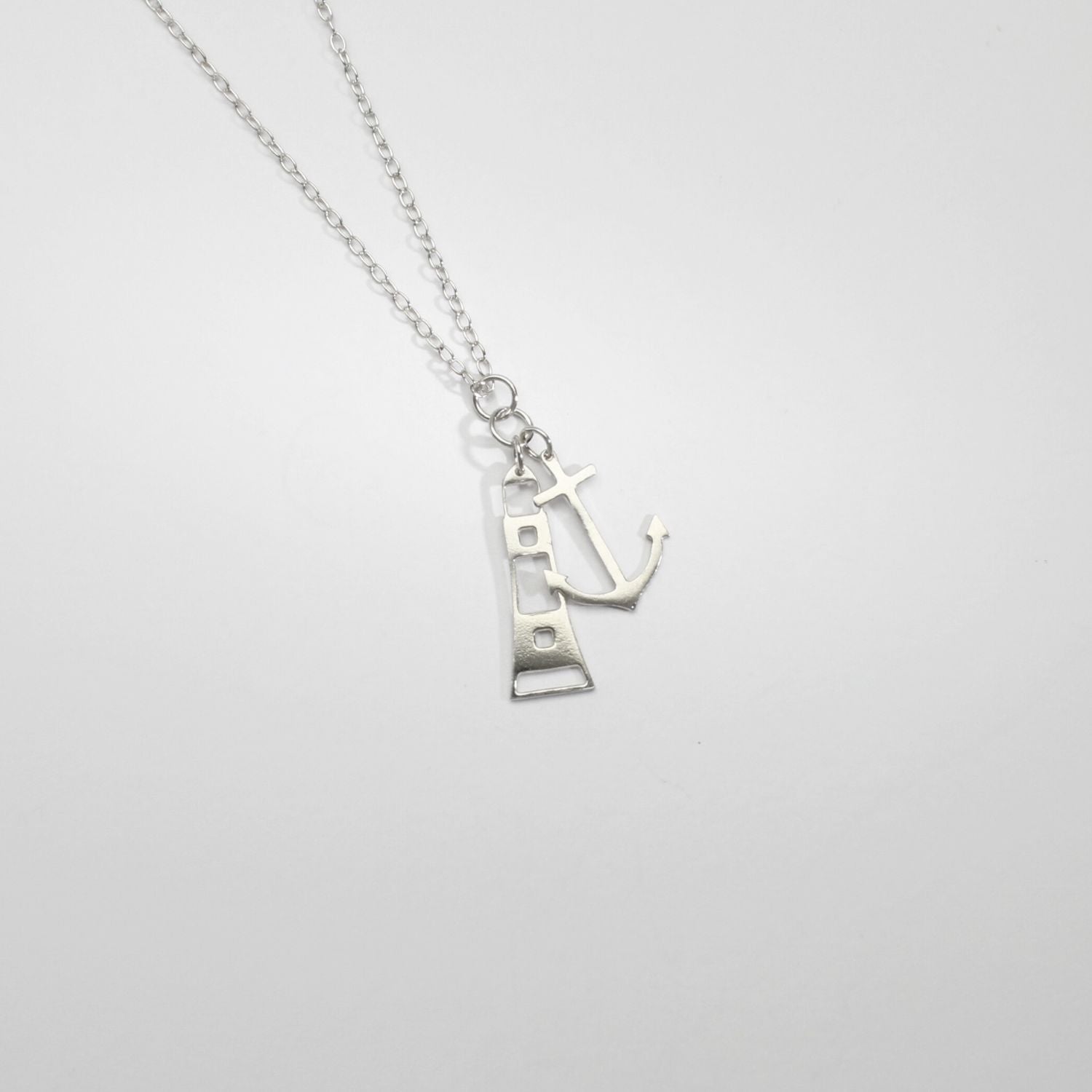 Anchor and lighthouse silver pendant by Kate Wimbush