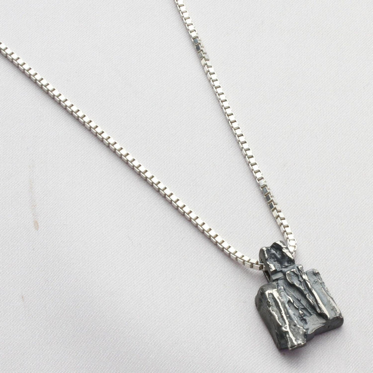 Contemporary Welsh silver jewellery. Inspired by the beautiful landscape of Wales especially slate and anthracite coal. This small textured pendant is designed and handmade in Wales
