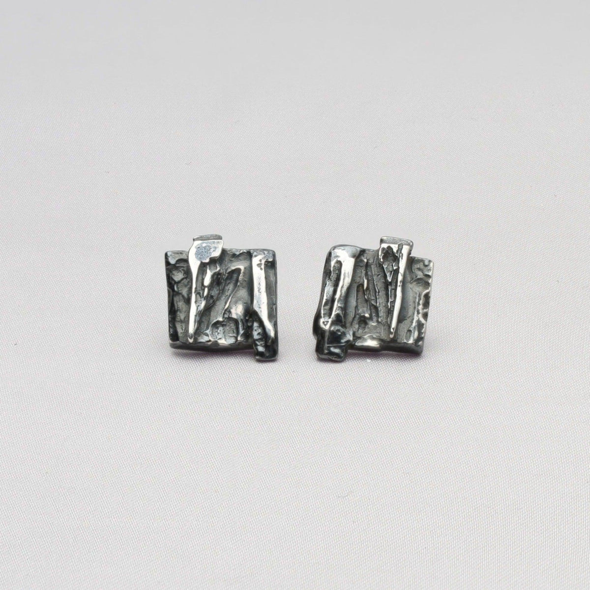 Contemporary Welsh silver jewellery. Inspired by Welsh slate and coal and the beautiful landscape of Wales.  These black oxidised square stud earrings are designed and handmade in Wales