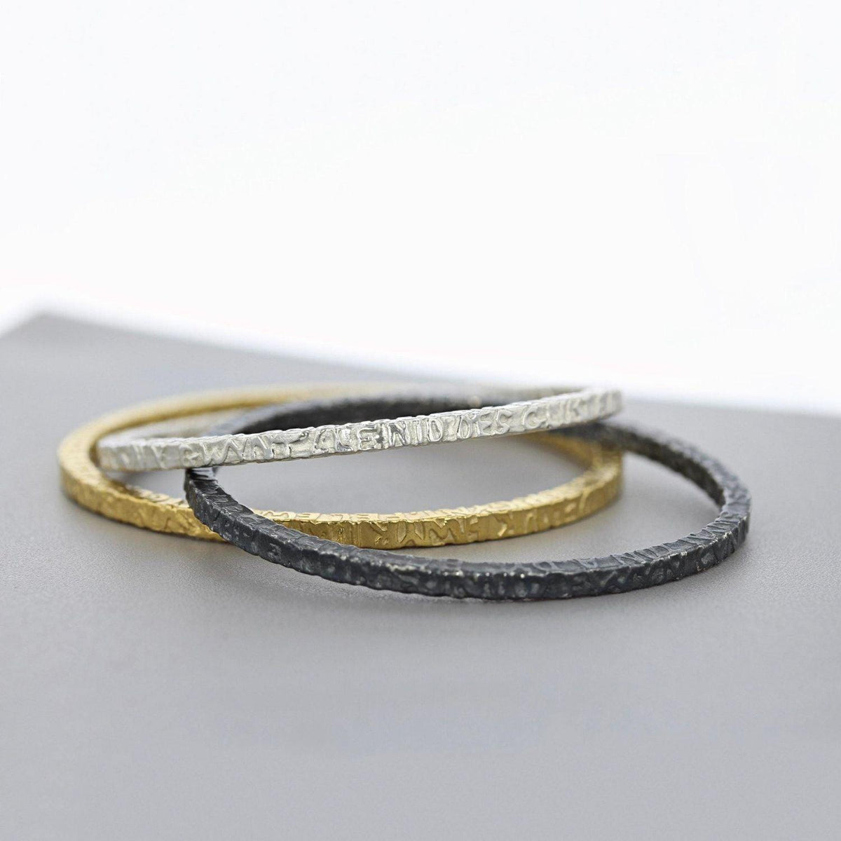 Close-up on the Cofio bangle, engraved with a verse of remembrance — Breichled Arian ac Aur