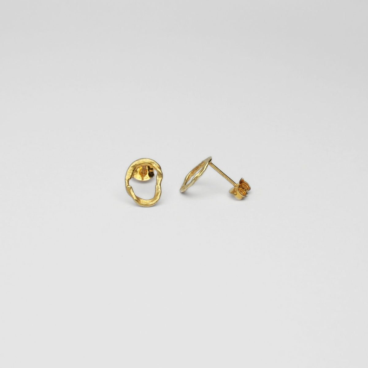 Organic flat circle shaped gold plated studs by Bea Jareno