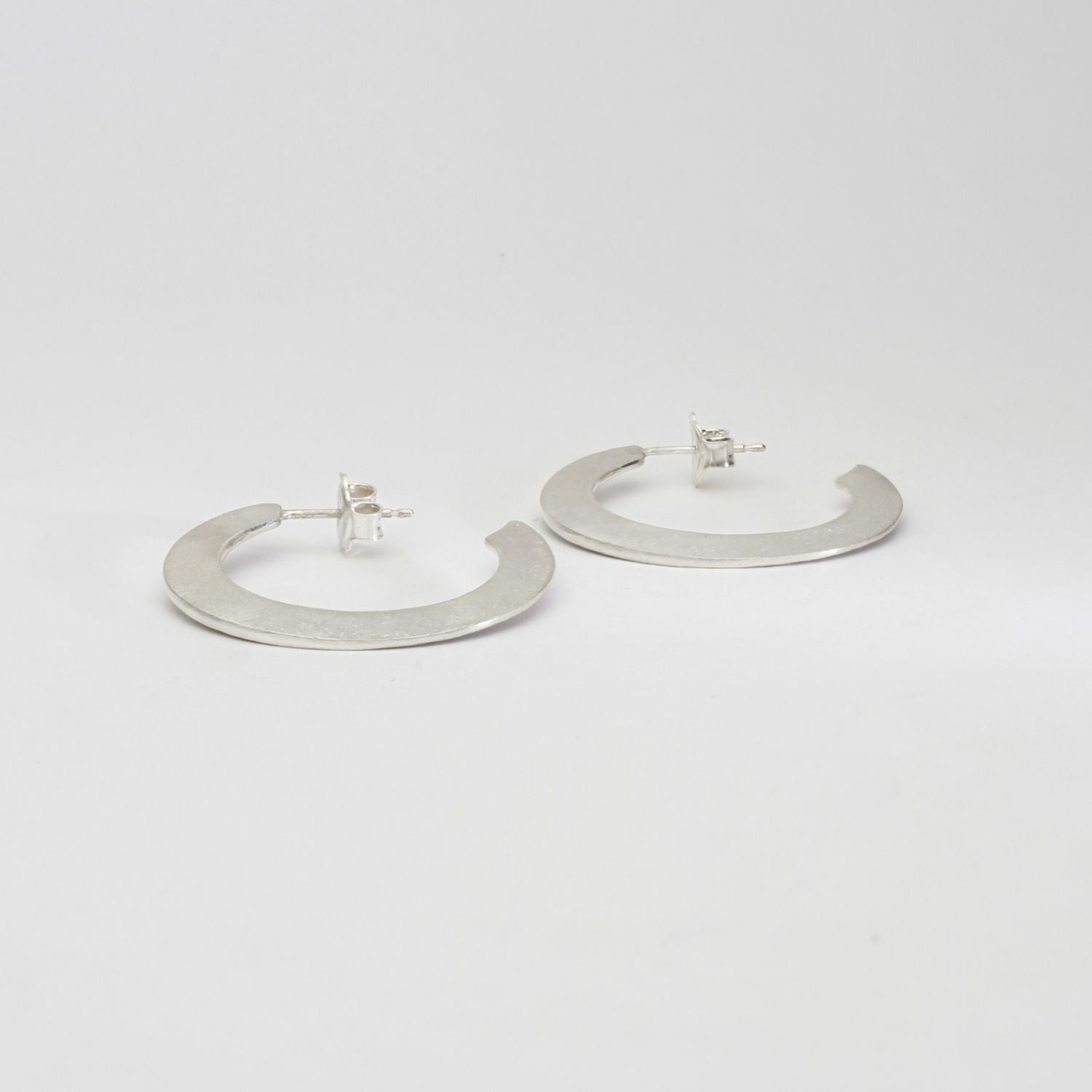Large silver hoops by Bea Jareno