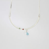 Semi-circle silver pendant with blue topaz, tourmaline & garnet by Bea Jareno
