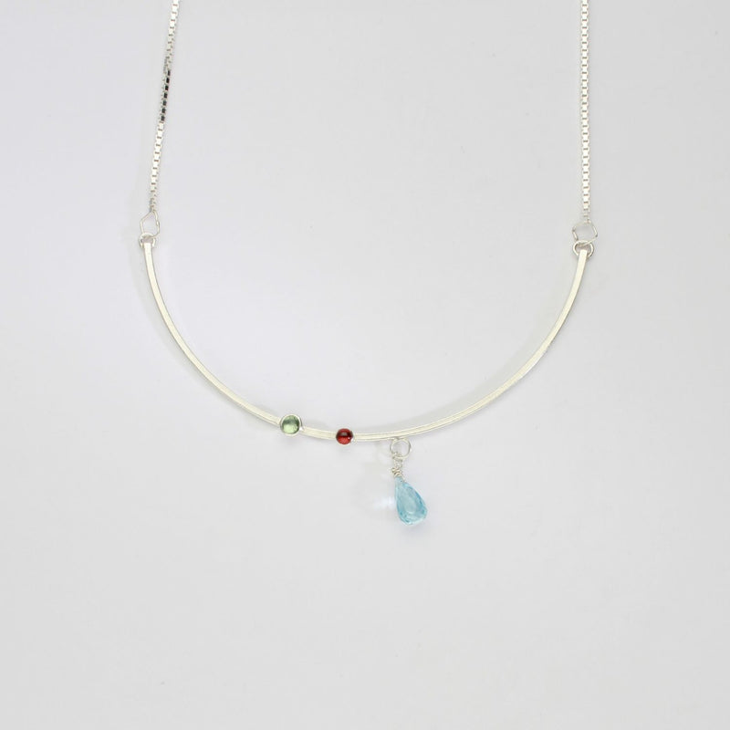 Semi-circle silver pendant with blue topaz, tourmaline & garnet by Bea Jareno