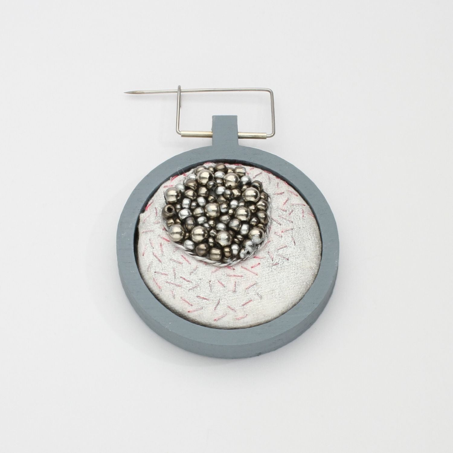 Brooch - Beading on cotton with stem stitch & seeding by Beatrice Mayfield