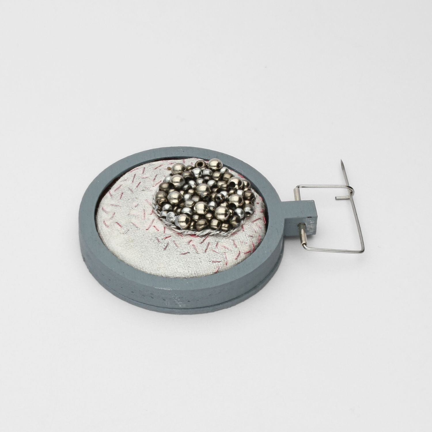 Brooch - Beading on cotton with stem stitch & seeding by Beatrice Mayfield