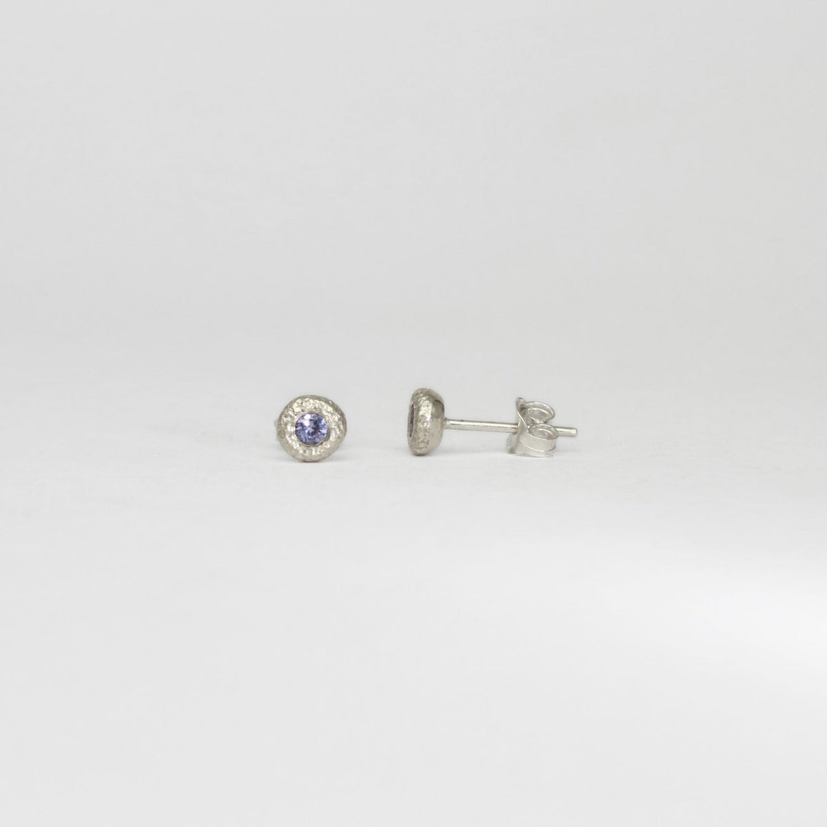 Textured pebble silver studs with tanzanite by Blae Maddrell