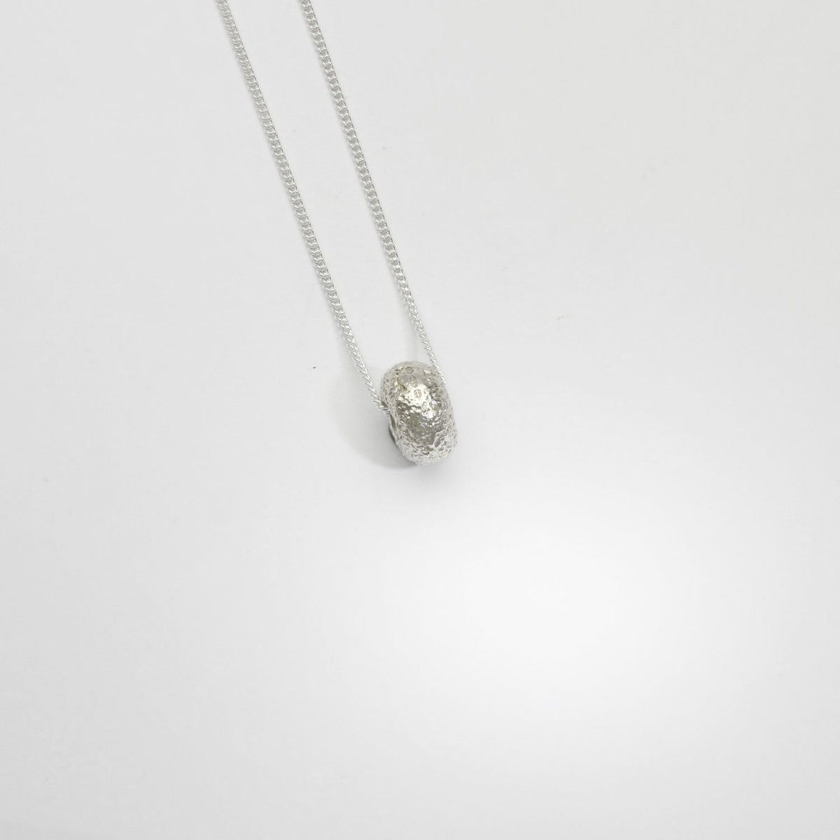 Textured round silver pendant by Blae Maddrell