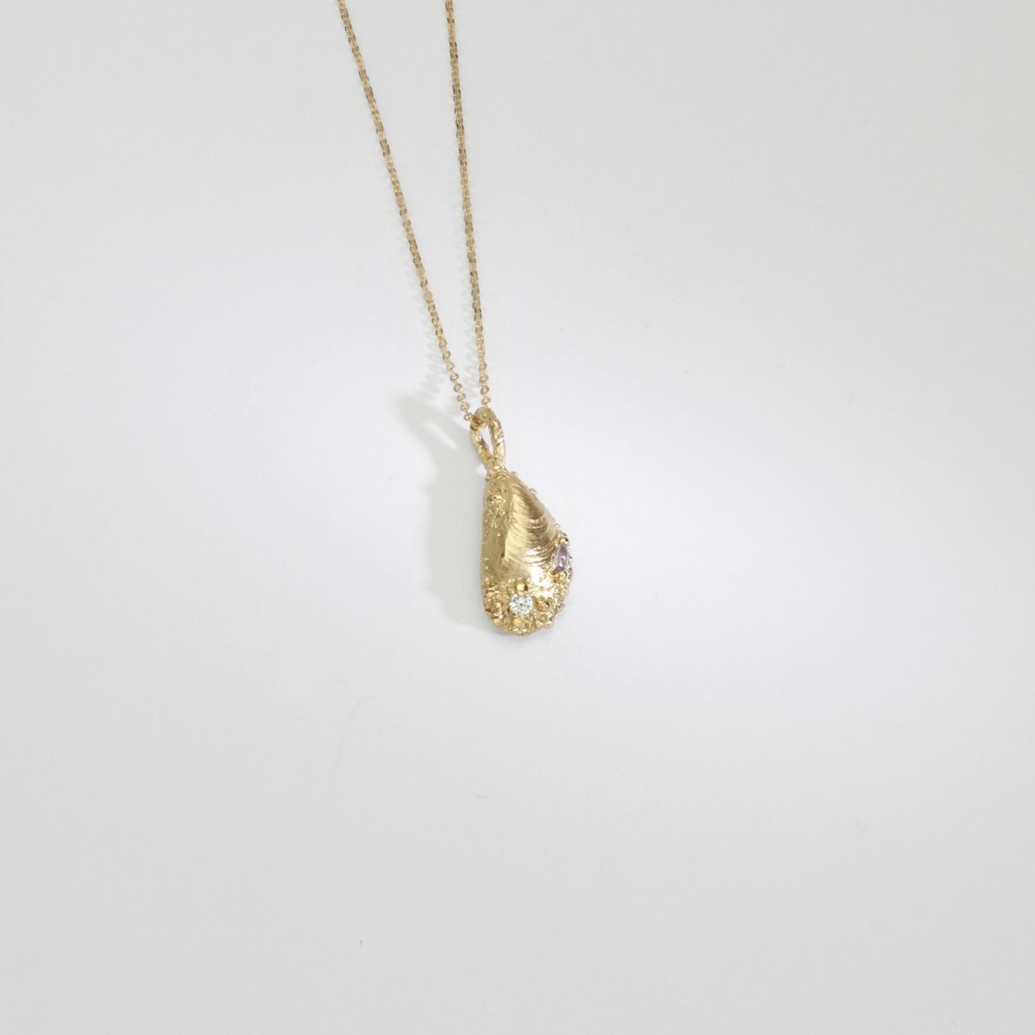 9ct gold muscle shell necklace with salt & pepper diamond & tanzanite by Blae Maddrell