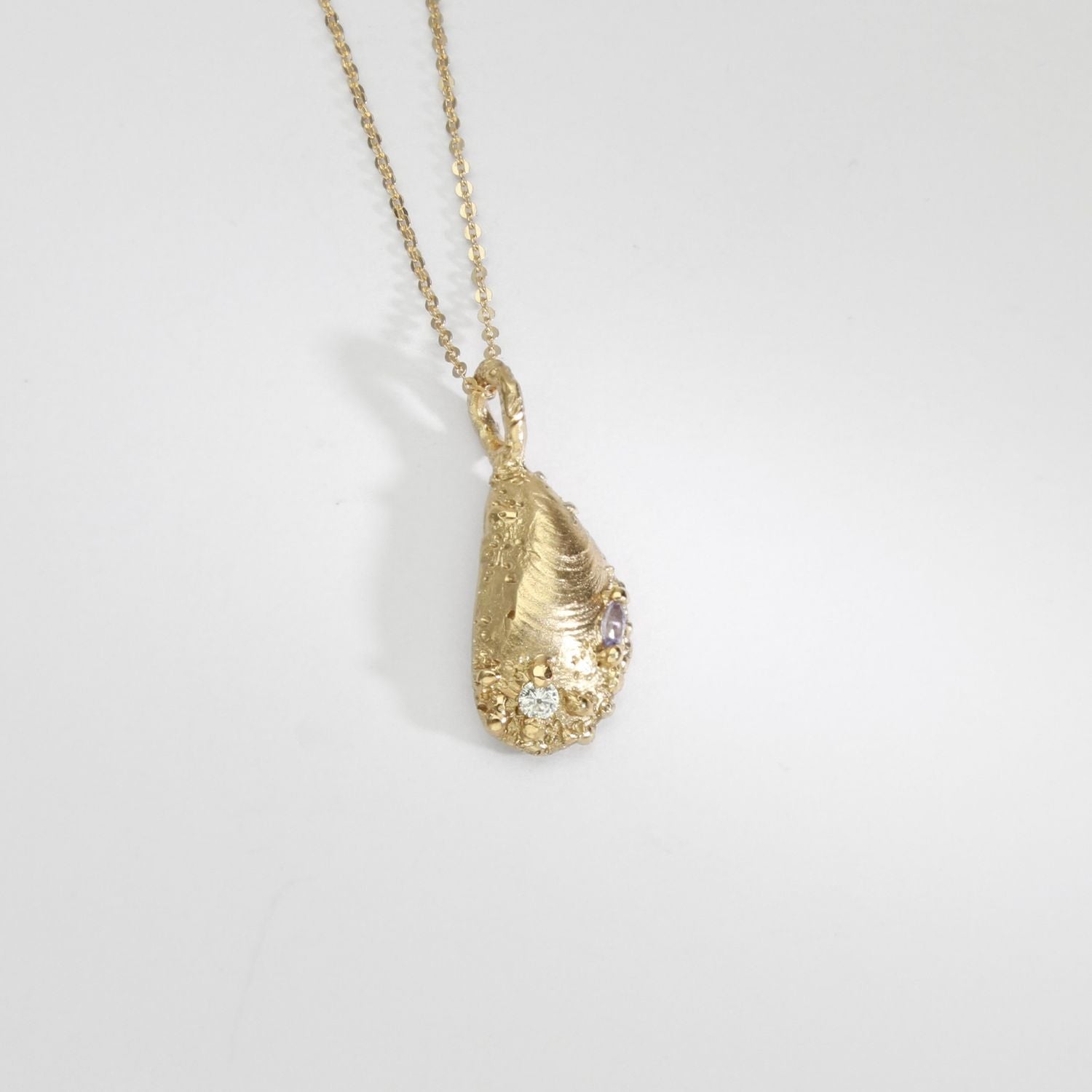 9ct gold muscle shell necklace with salt & pepper diamond & tanzanite by Blae Maddrell