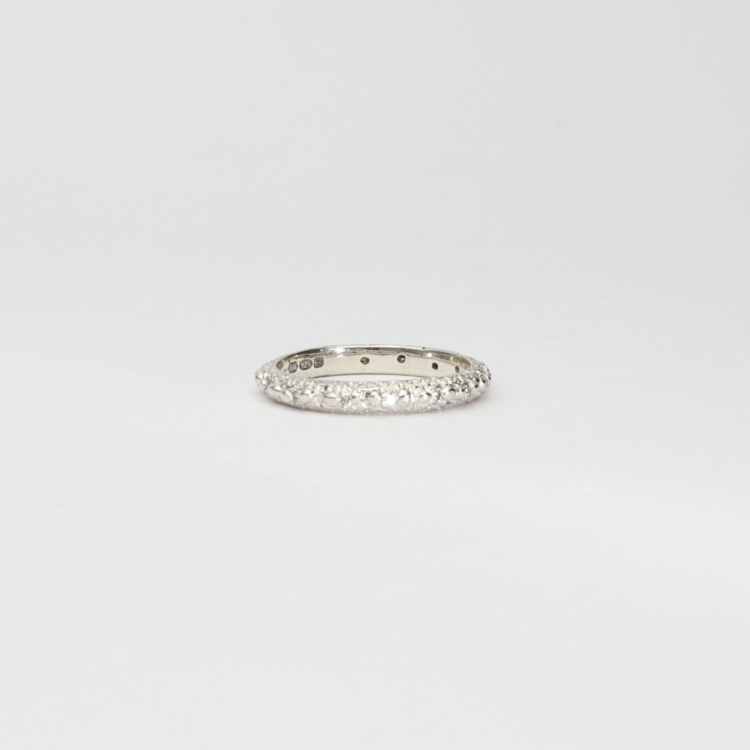 Silver eternity sand band with small moissanites by Blae Maddrell