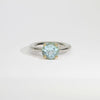 Halo silver ring with a round topaz in a 18ct setting by Charmian Ottaway