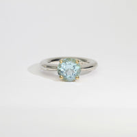 Halo silver ring with a round topaz in a 18ct setting by Charmian Ottaway