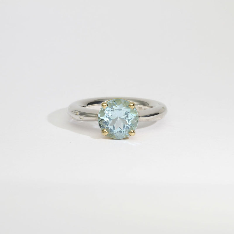 Halo silver ring with a round topaz in a 18ct setting by Charmian Ottaway