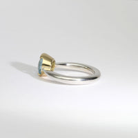 Halo silver ring with blue topaz in 18ct setting by Charmian Ottaway