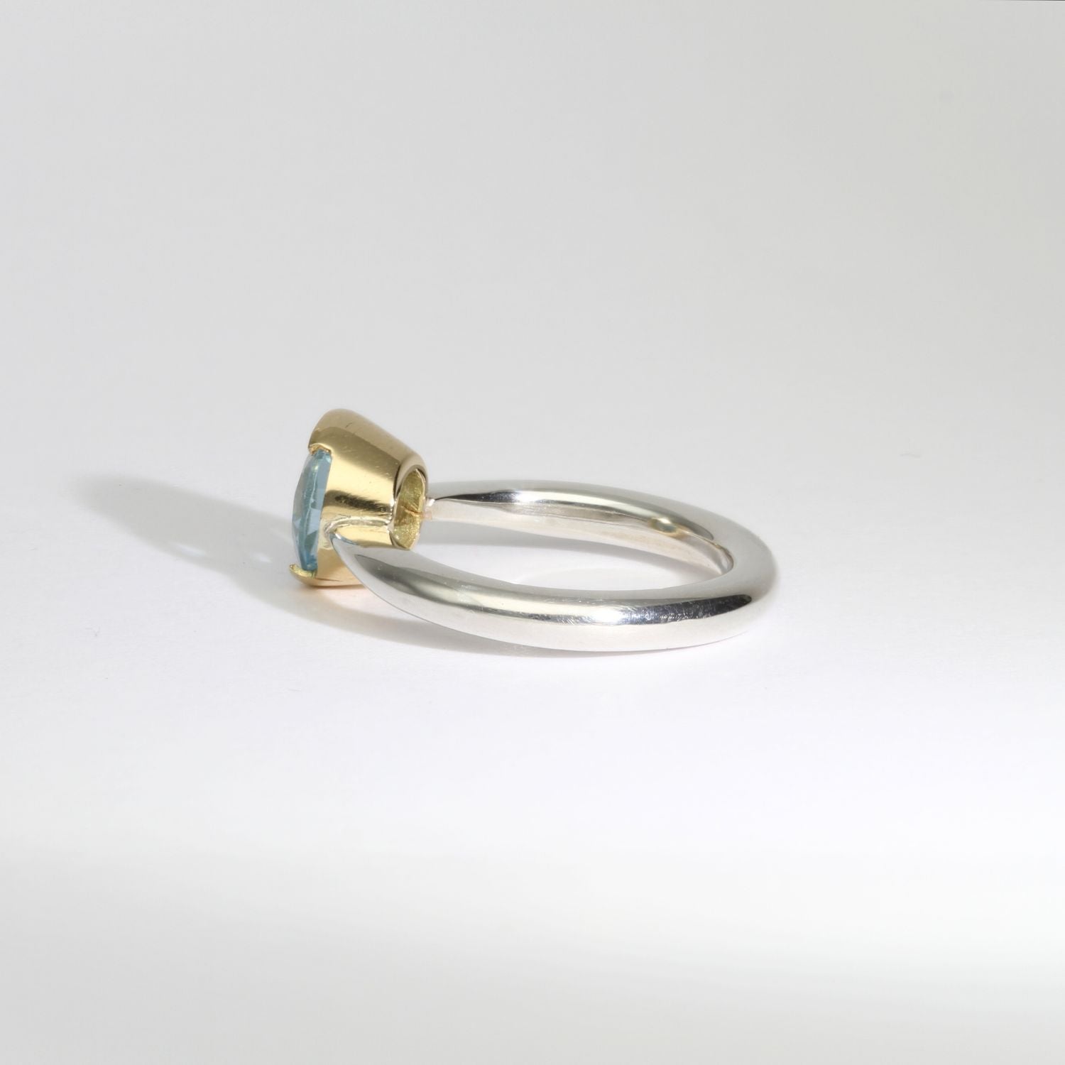 Halo silver ring with blue topaz in 18ct setting by Charmian Ottaway