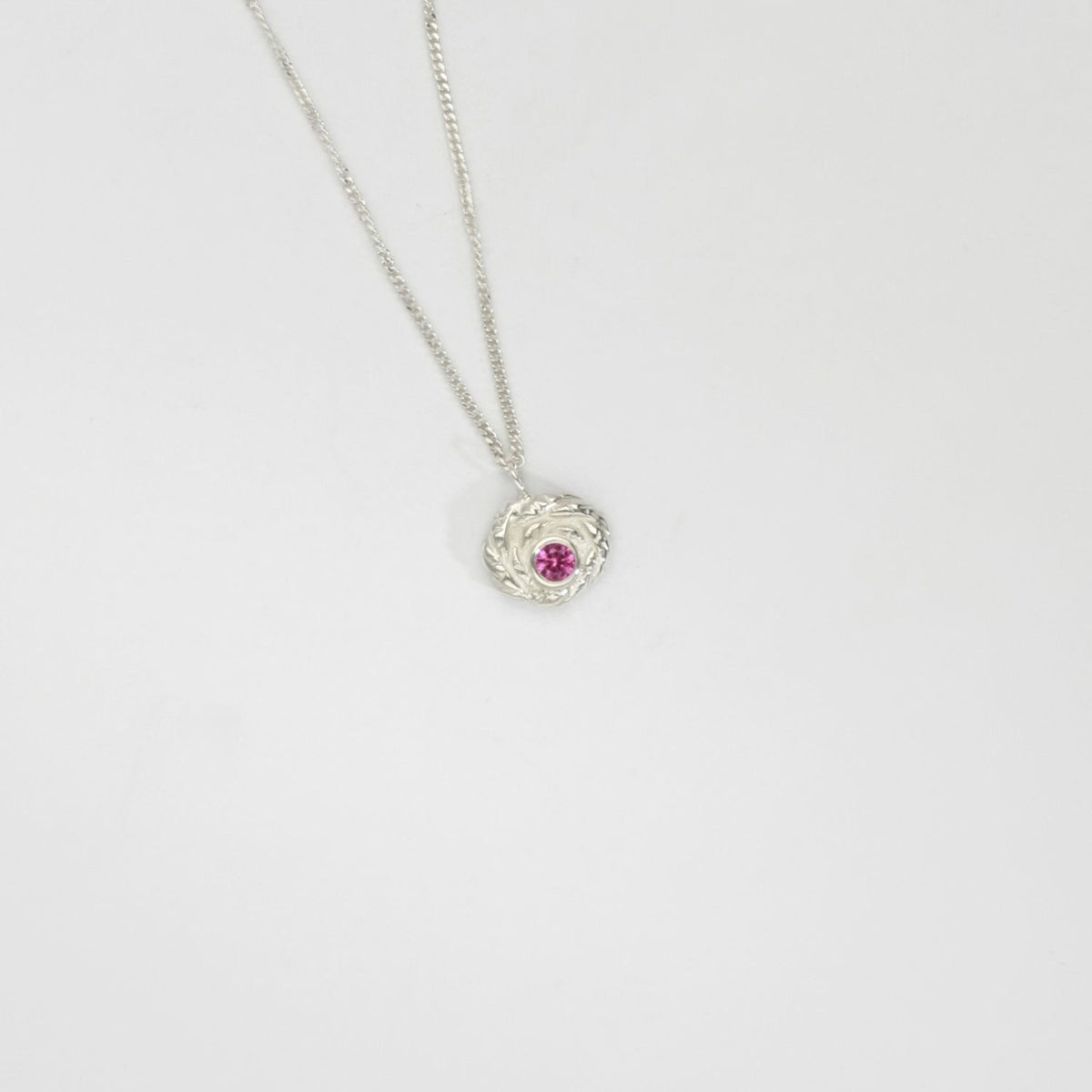 Twisted silver pendant with pink sapphire by Charlotte Reid