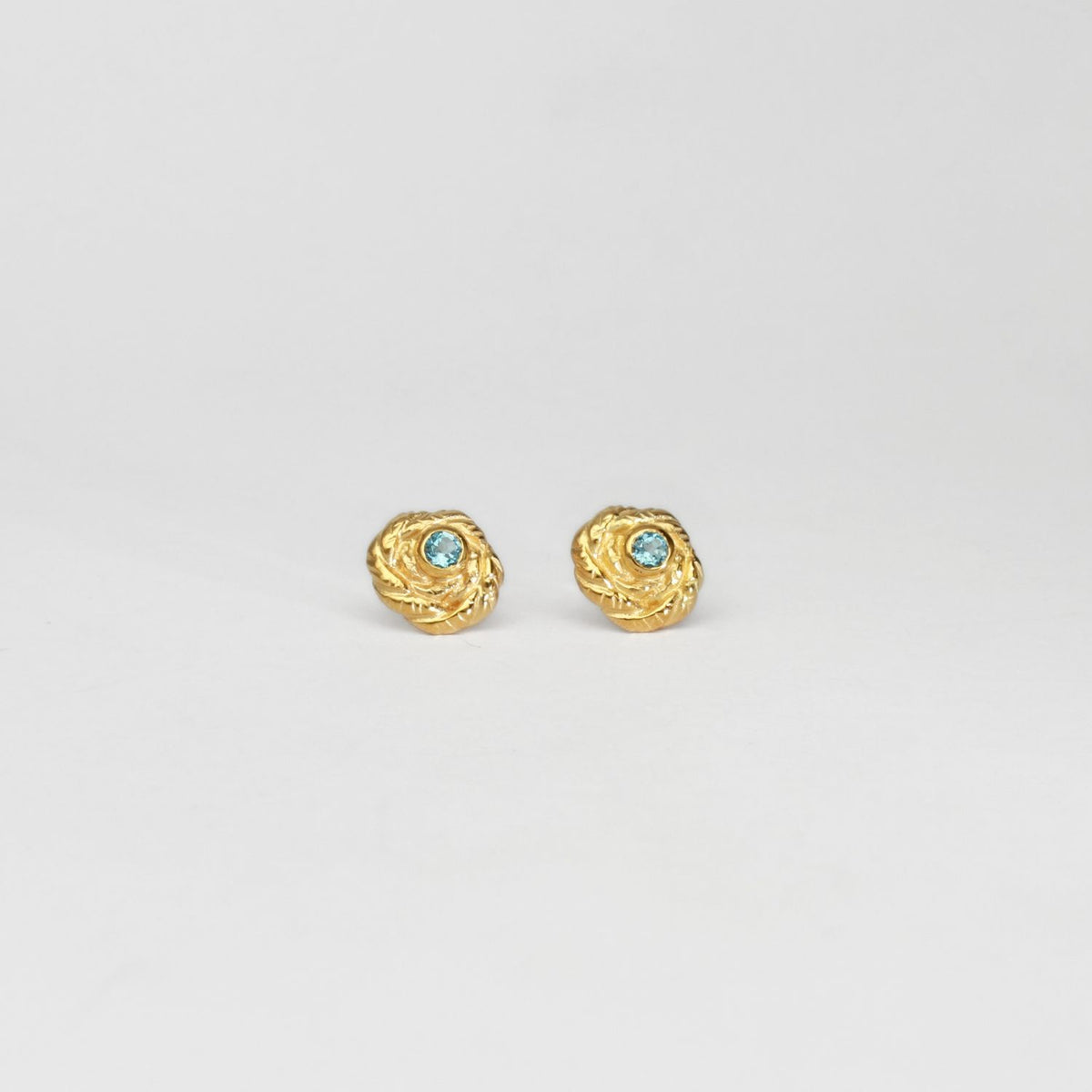 Twisted silver 22ct gold plated studs with sky blue topaz by Charlotte Reid