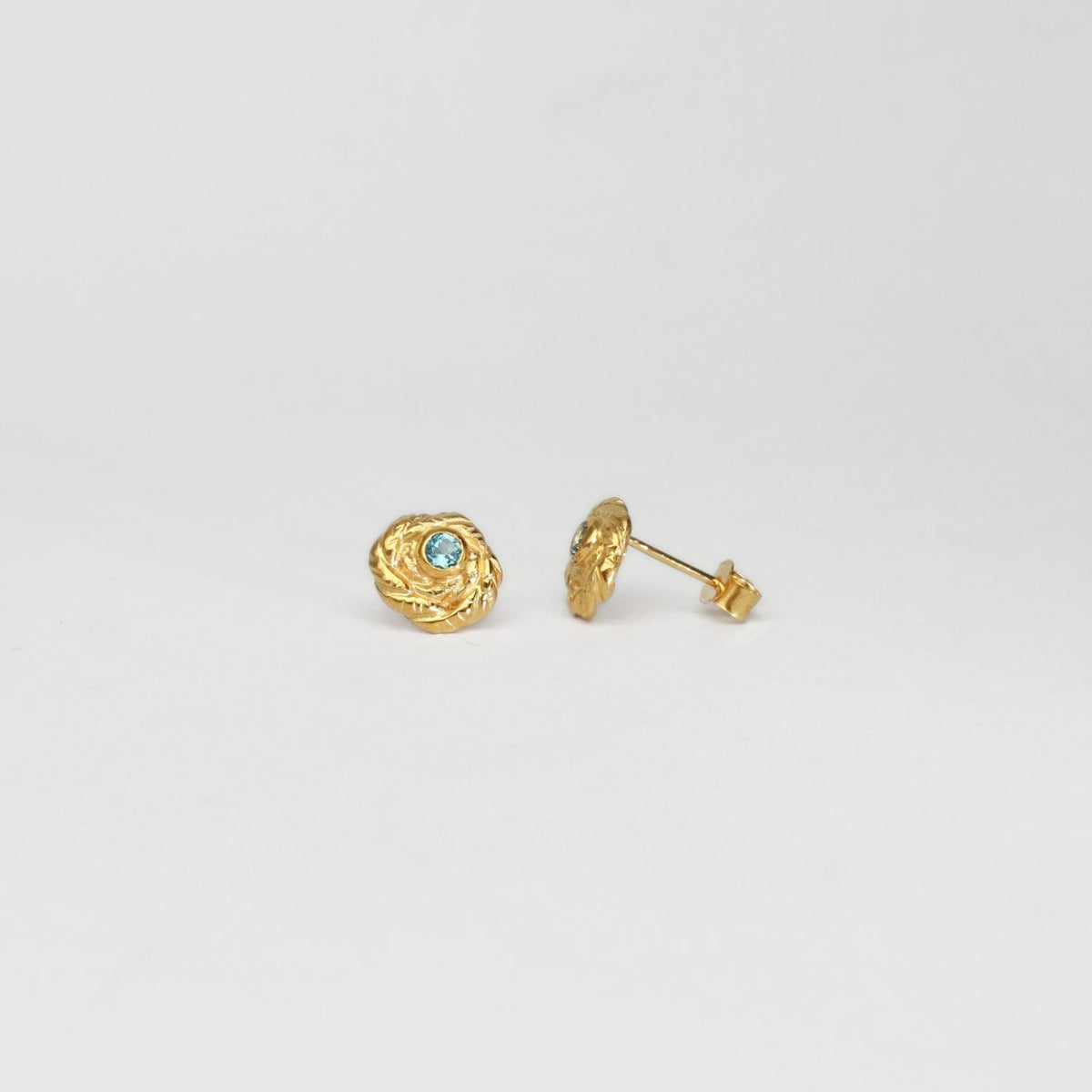 Twisted silver 22ct gold plated studs with sky blue topaz by Charlotte Reid