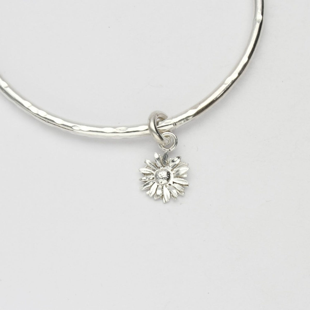 Daisy silver charm bangle by Emily Craig