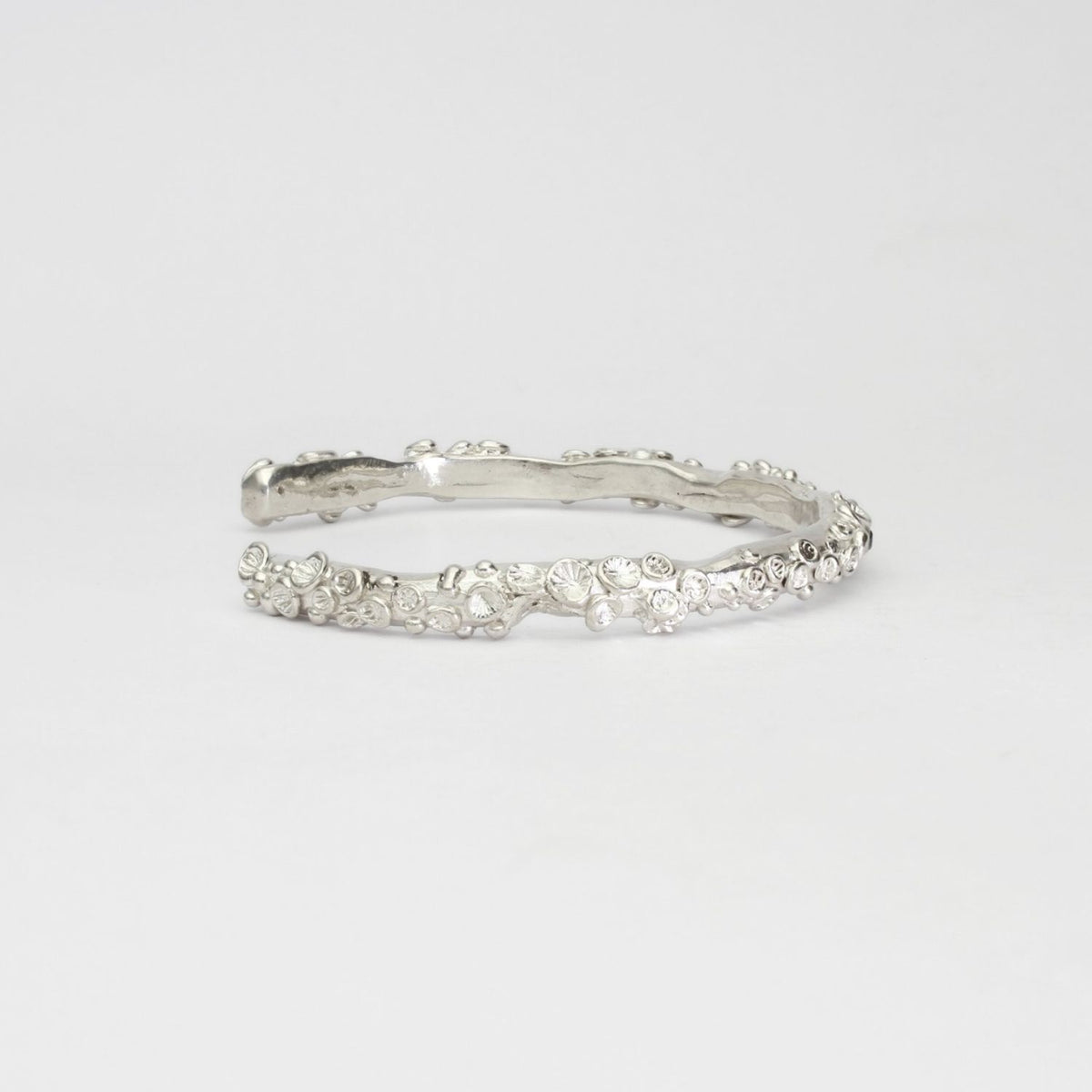 Rockpool silver torque bangle with sapphires by Emily Craig