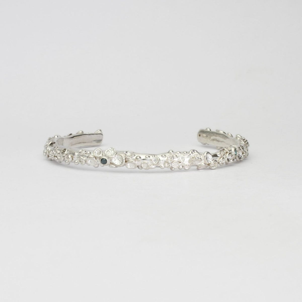 Rockpool silver torque bangle with sapphires by Emily Craig