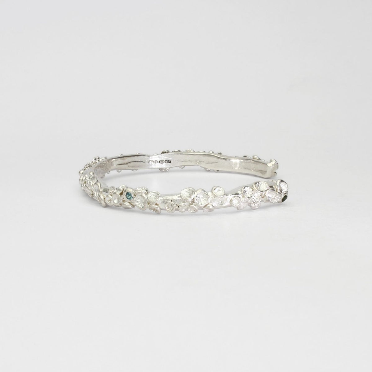 Rockpool silver torque bangle with sapphires by Emily Craig