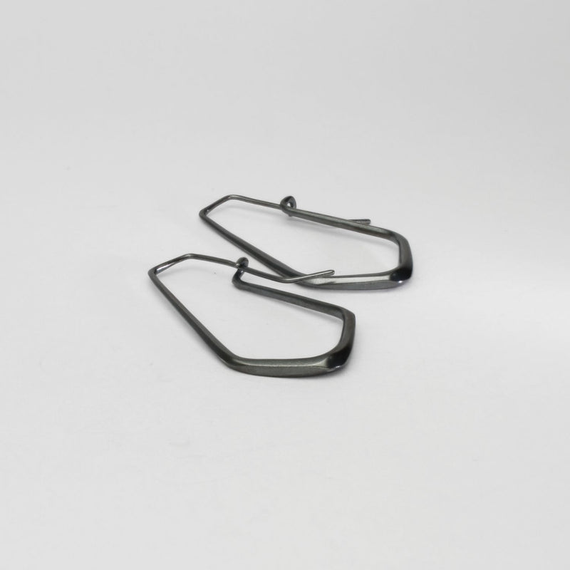 Short forged black silver hoop earrings by Emily Thatcher
