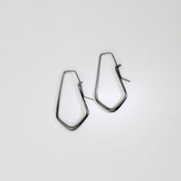 Short forged black silver hoop earrings by Emily Thatcher