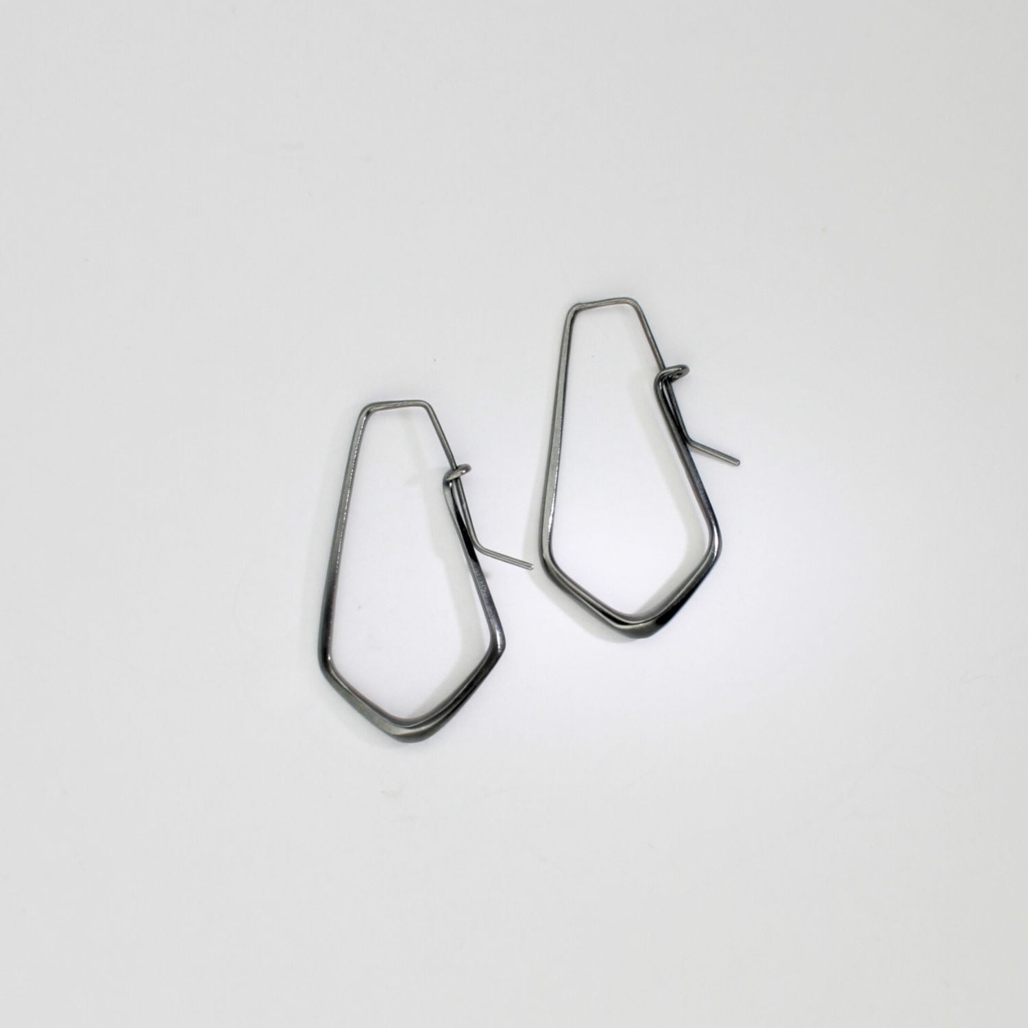 Short forged black silver hoop earrings by Emily Thatcher
