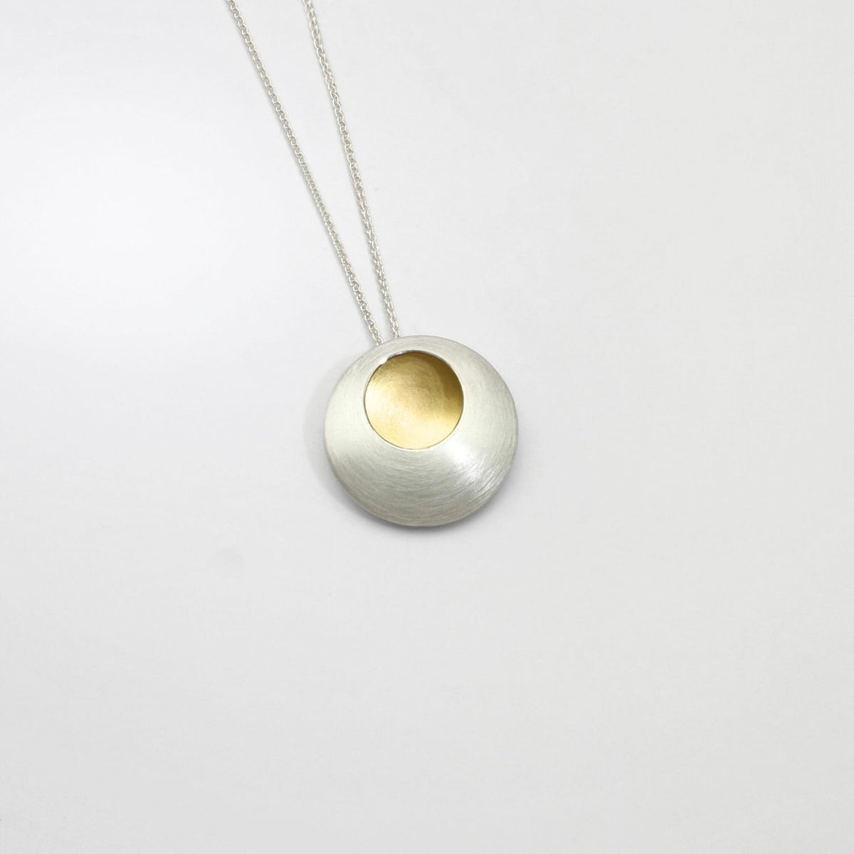 Large pebble silver & gold plated pendant by Hannah Souter