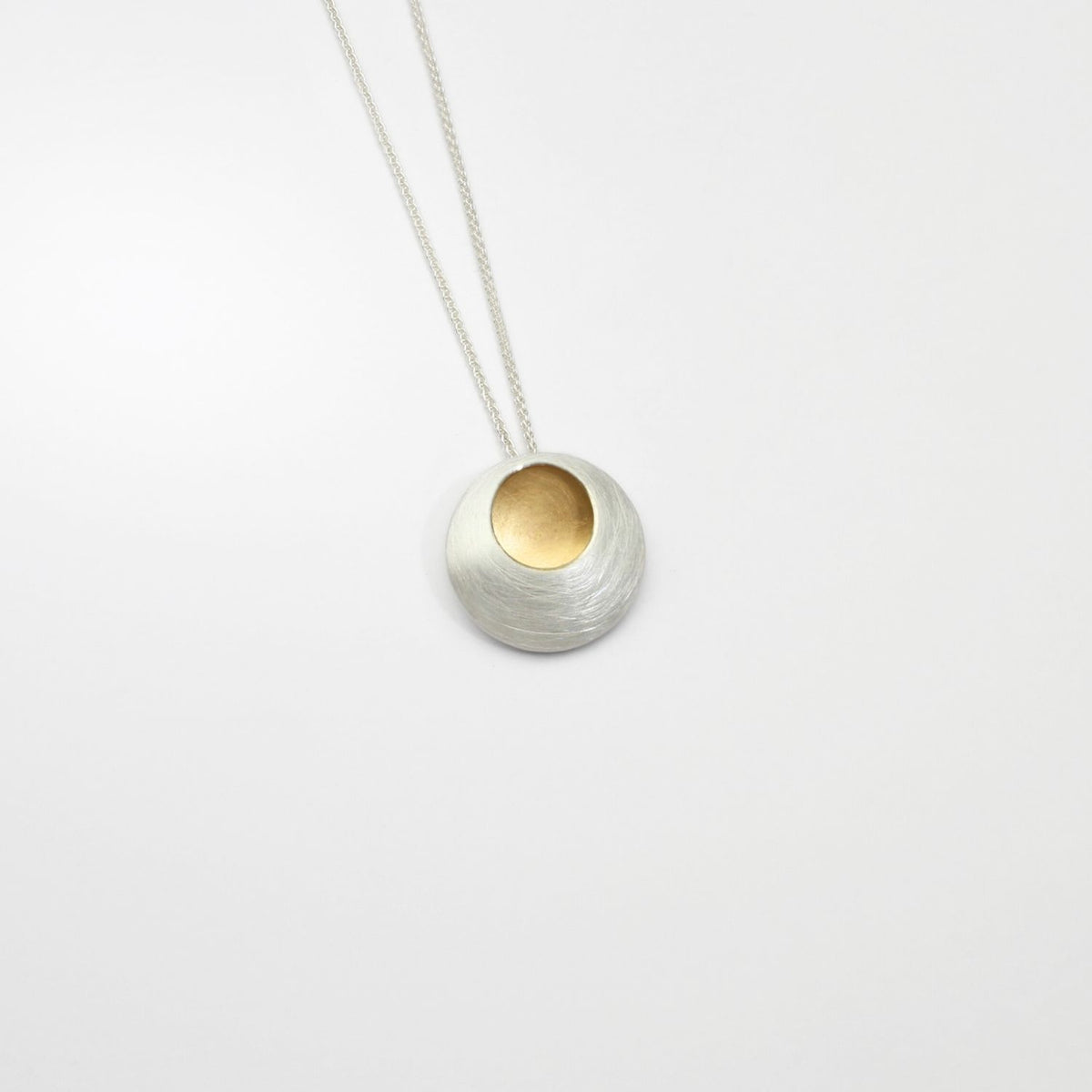 Small pebble silver & gold plated pendant by Hannah Souter
