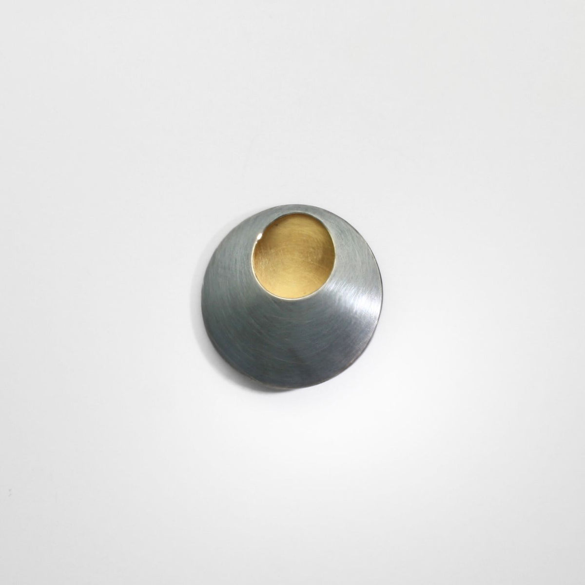 Pebble black silver & gold plated brooch by Hannah Souter