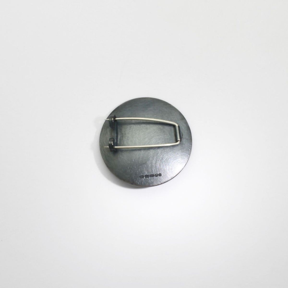 Pebble black silver & gold plated brooch by Hannah Souter