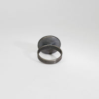 Small pebble black silver & gold plated ring by Hannah Souter