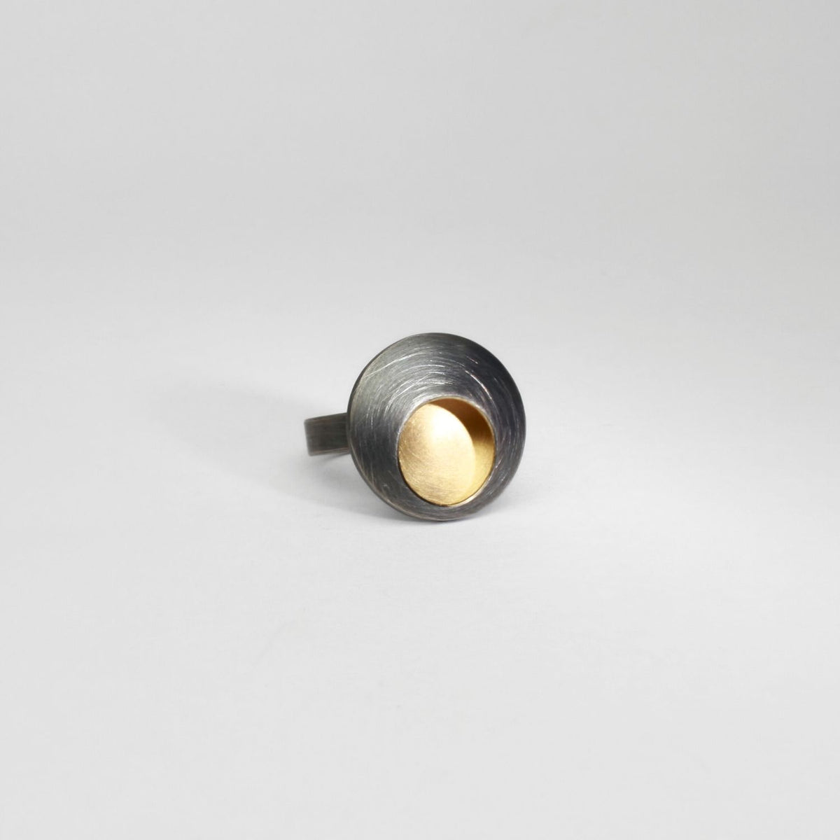 Small pebble black silver & gold plated ring by Hannah Souter