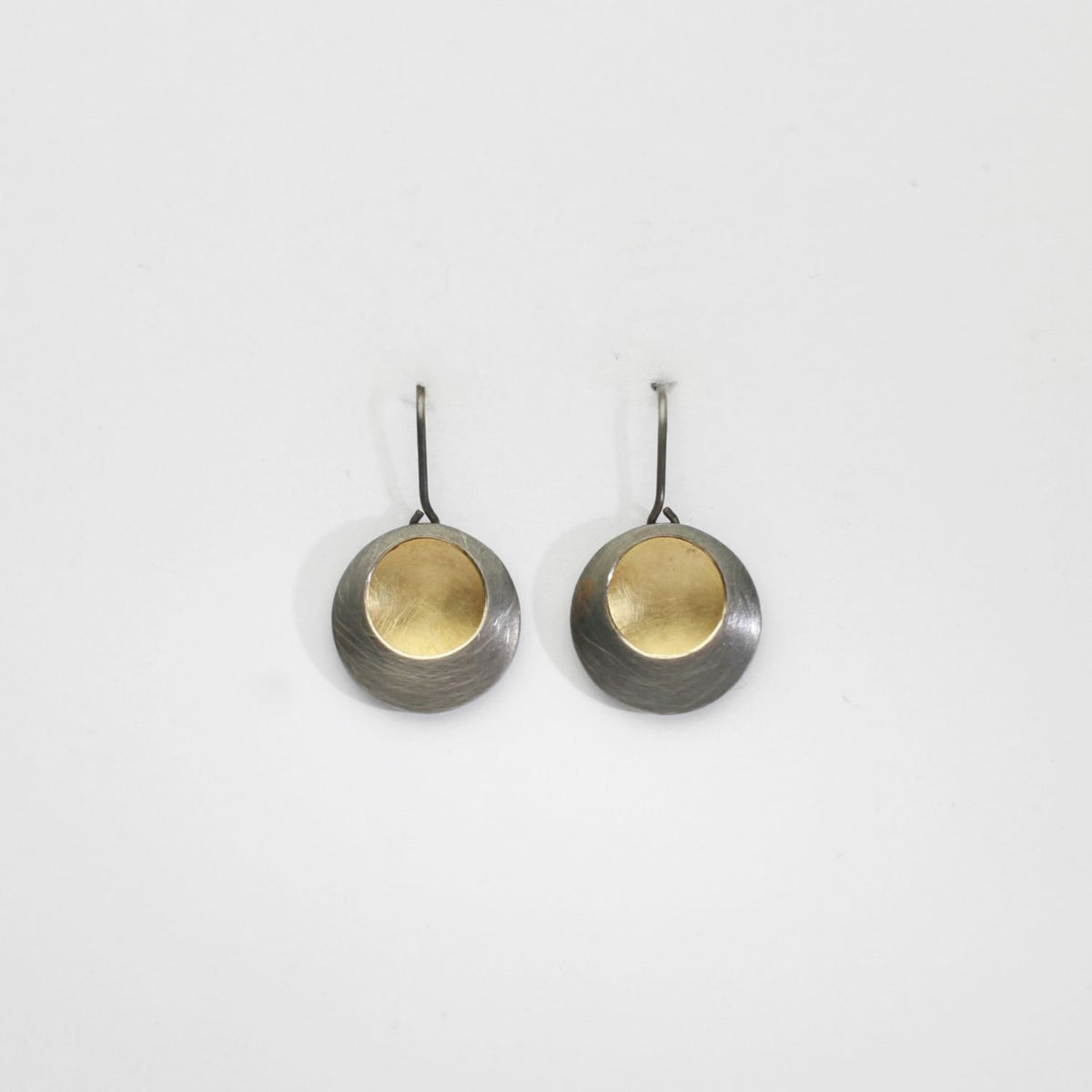 Pebble satin black silver & gold plated drop earrings by Hannah Souter