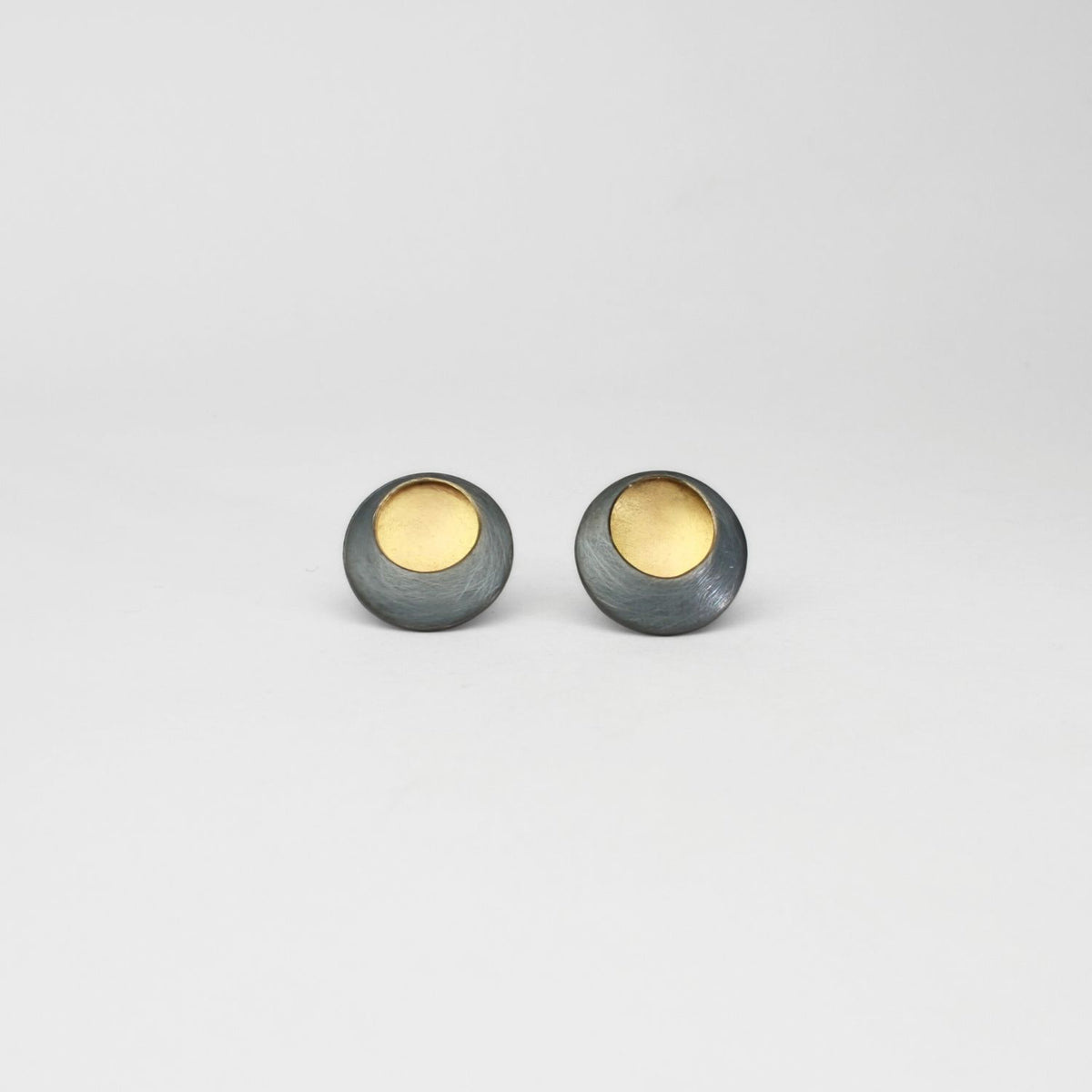 Pebble satin black silver & gold plated studs by Hannah Souter