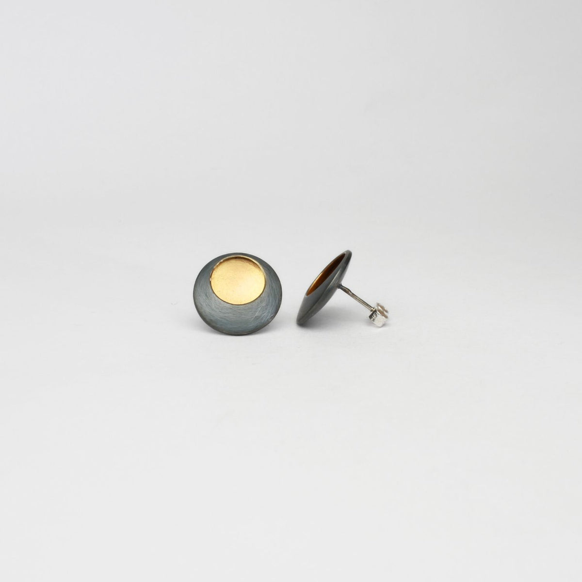 Pebble satin black silver & gold plated studs by Hannah Souter