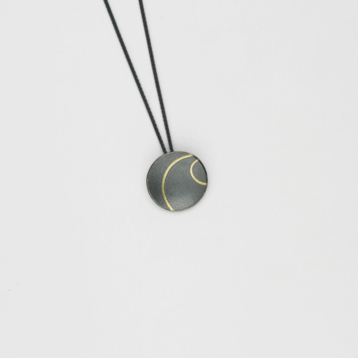 Small lunar 2 satin black silver & 18ct gold pendant by Hannah Souter