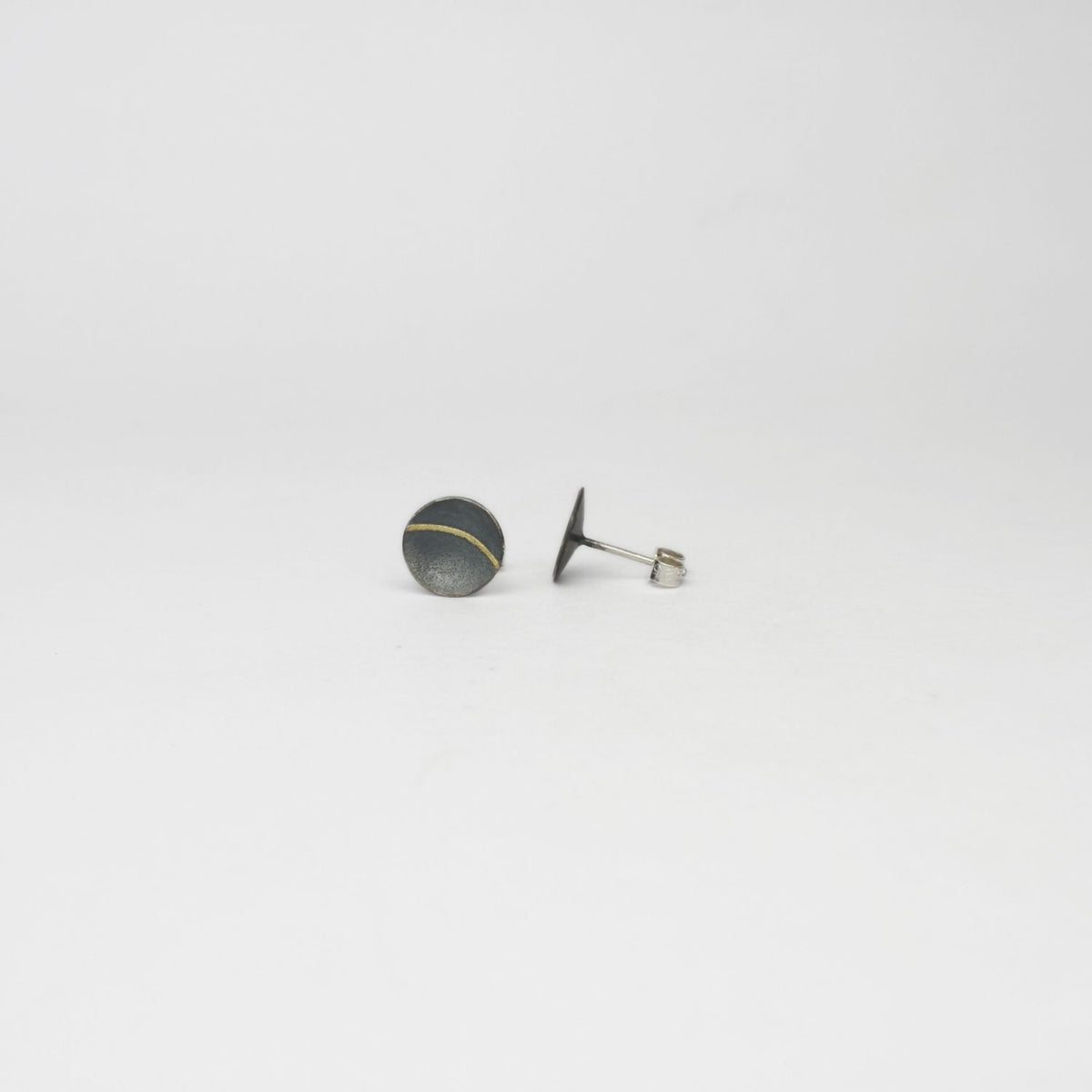 Small lunar 2 satin black silver & 18ct gold studs by Hannah Souter
