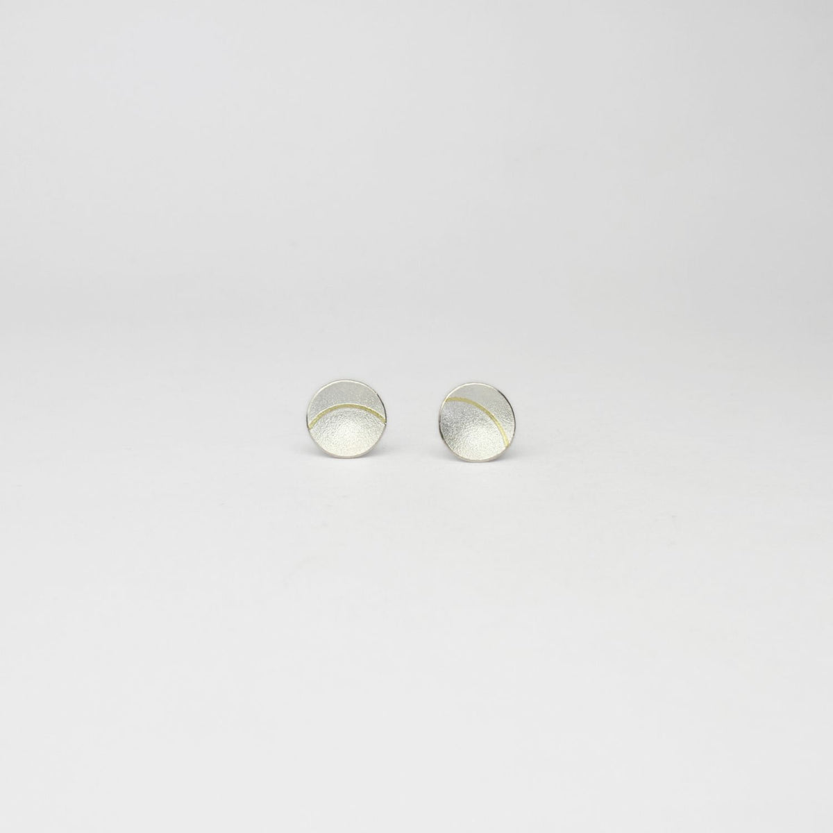 Small lunar 2 satin silver & 18ct gold studs by Hannah Souter