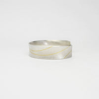 Lunar satin silver & 18ct gold cuff bangle by Hannah Souter