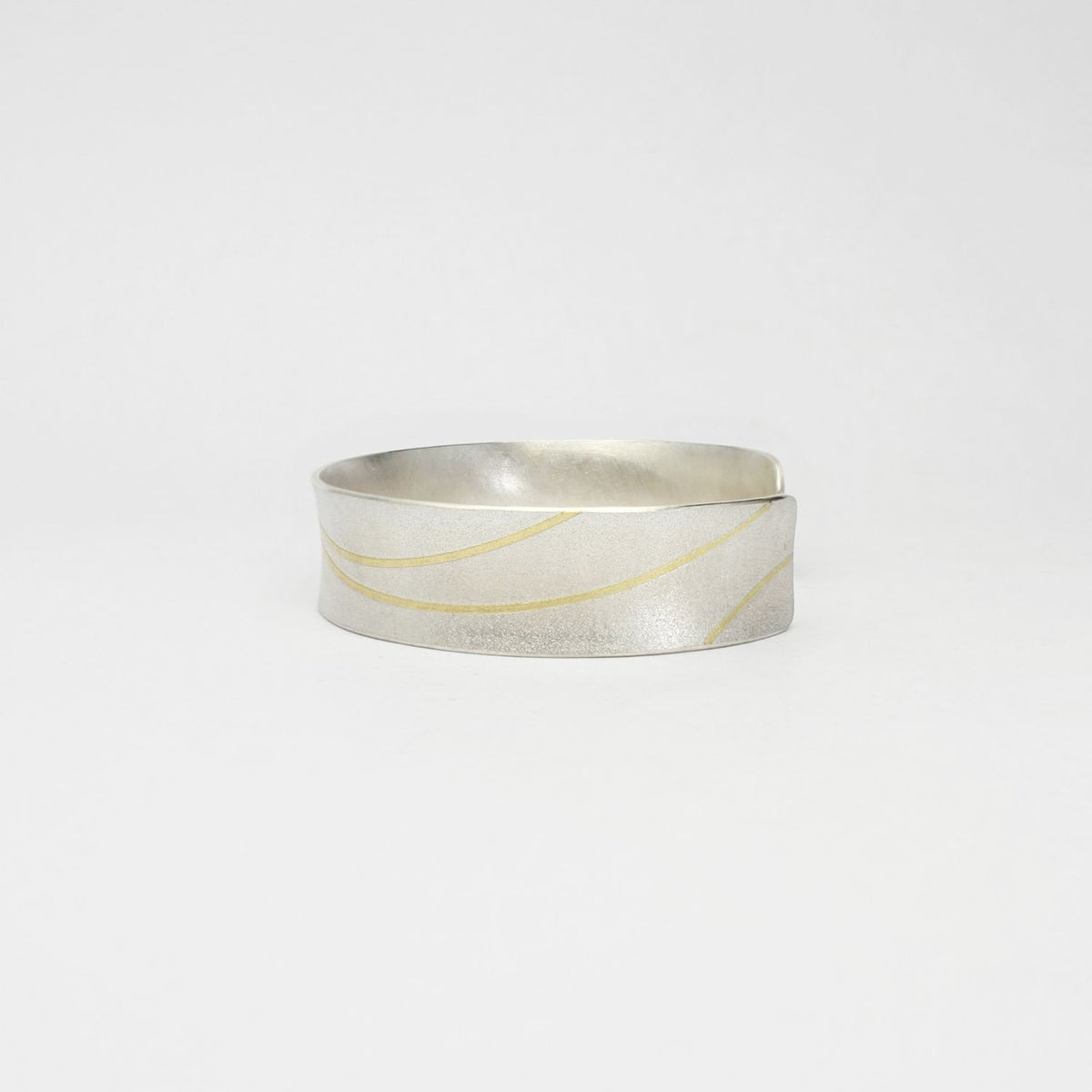 Lunar satin silver & 18ct gold cuff bangle by Hannah Souter