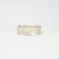 Lunar satin silver & 18ct gold cuff bangle by Hannah Souter