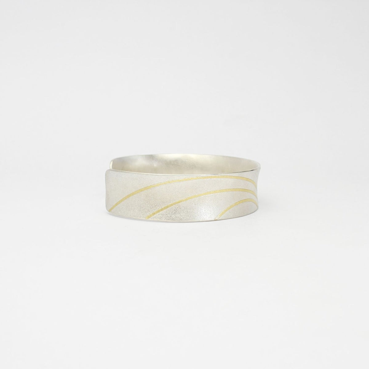 Lunar satin silver & 18ct gold cuff bangle by Hannah Souter