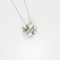 Large faceted ribbon knot tied silver pendant by Jodie Hook