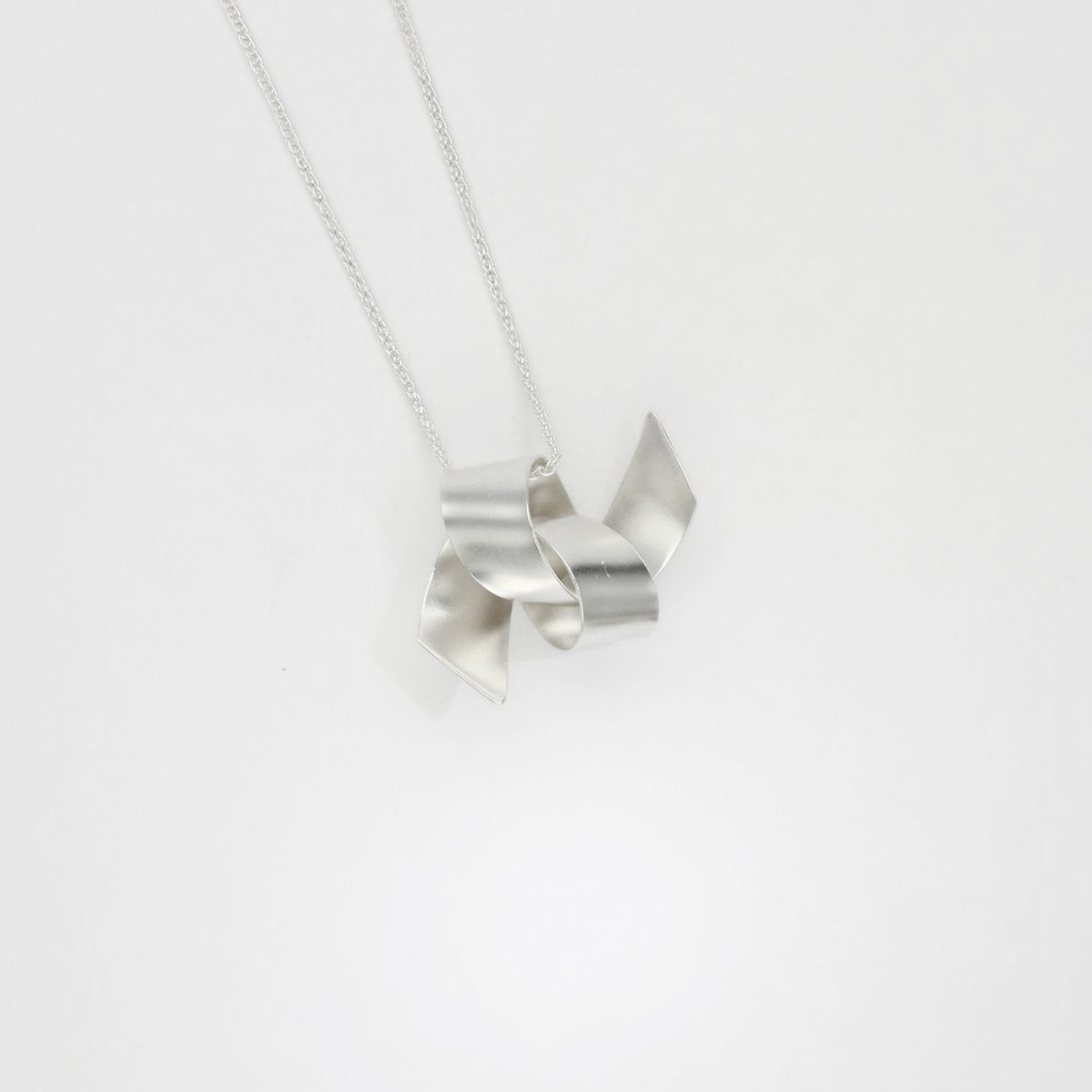 Large ribbon knot tied silver pendant by Jodie Hook
